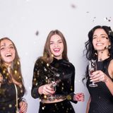 happy-women-standing-with-champagne-glasses-spangles_23-2147989996